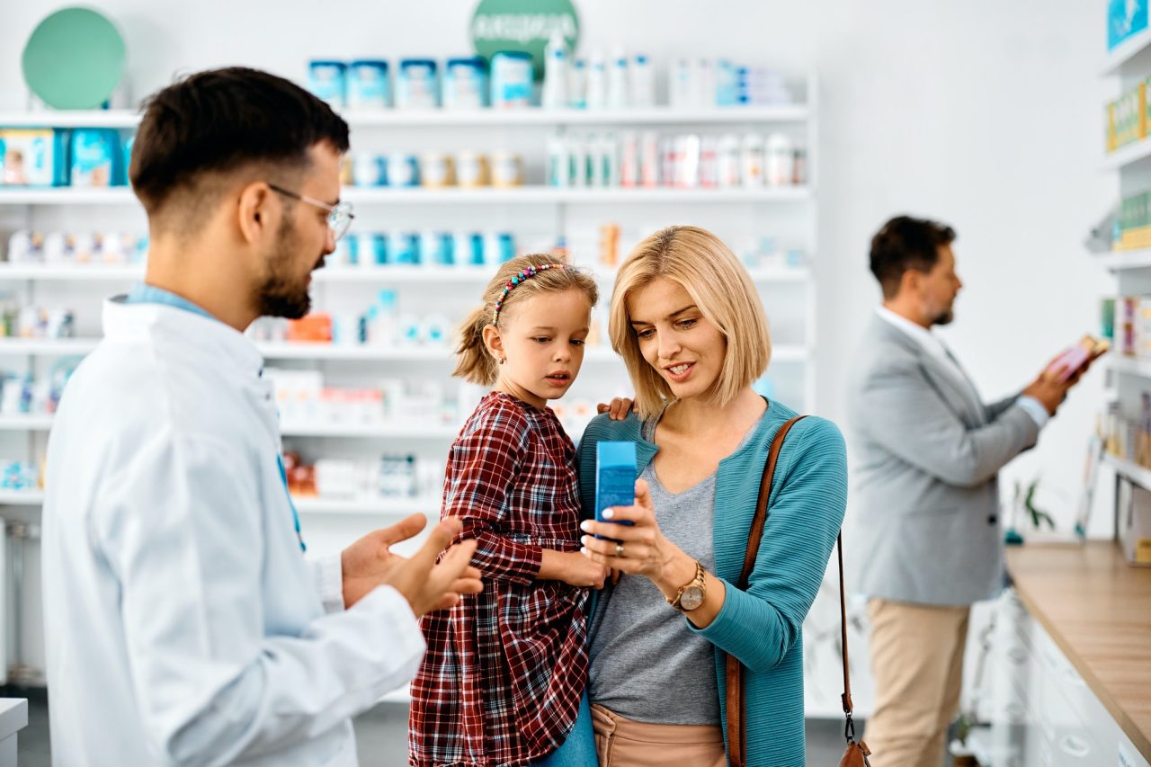 Happy mother with daughter buying in a pharmacy .jpg